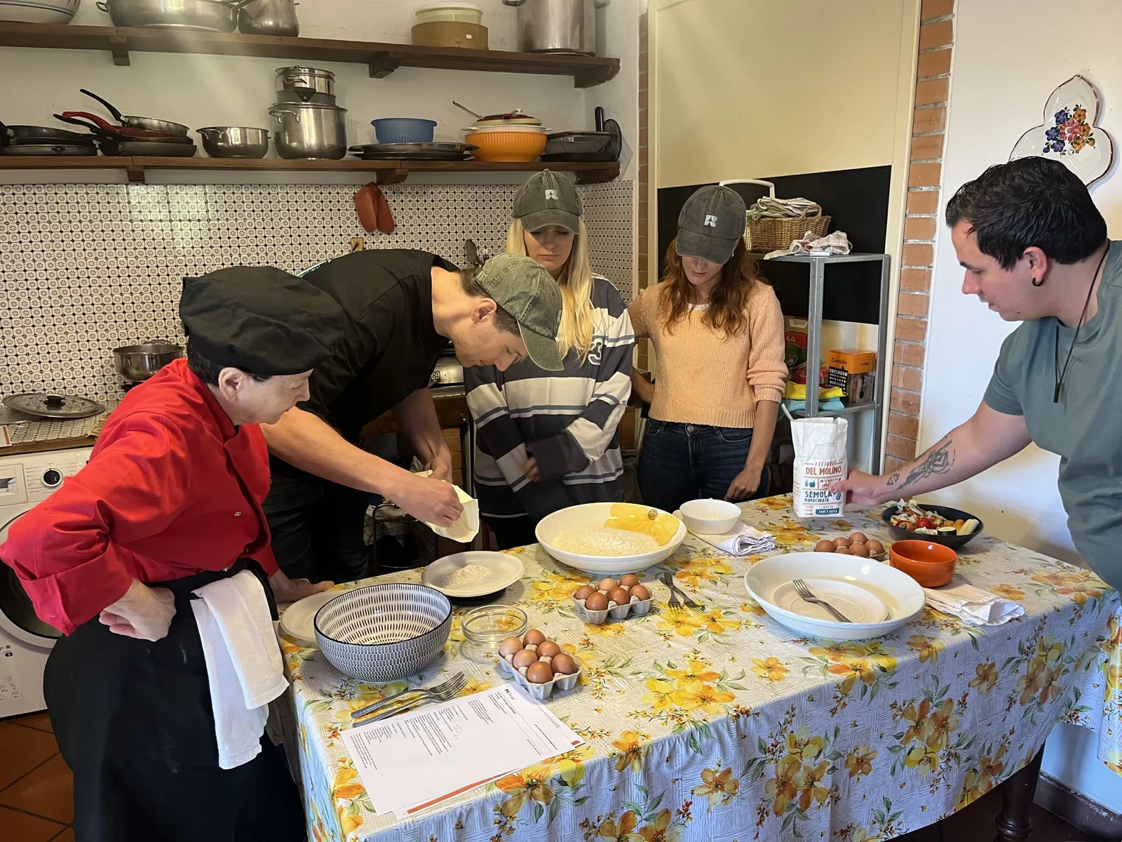 Range team members at a pasta-making class on an offsite in Italy