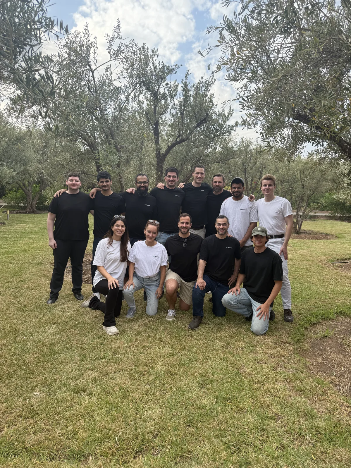 Range team members at an offsite in an olive grove